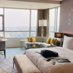 Neutral luxury bedroom with fitted sheet on bed – blog cover for custom bedding
